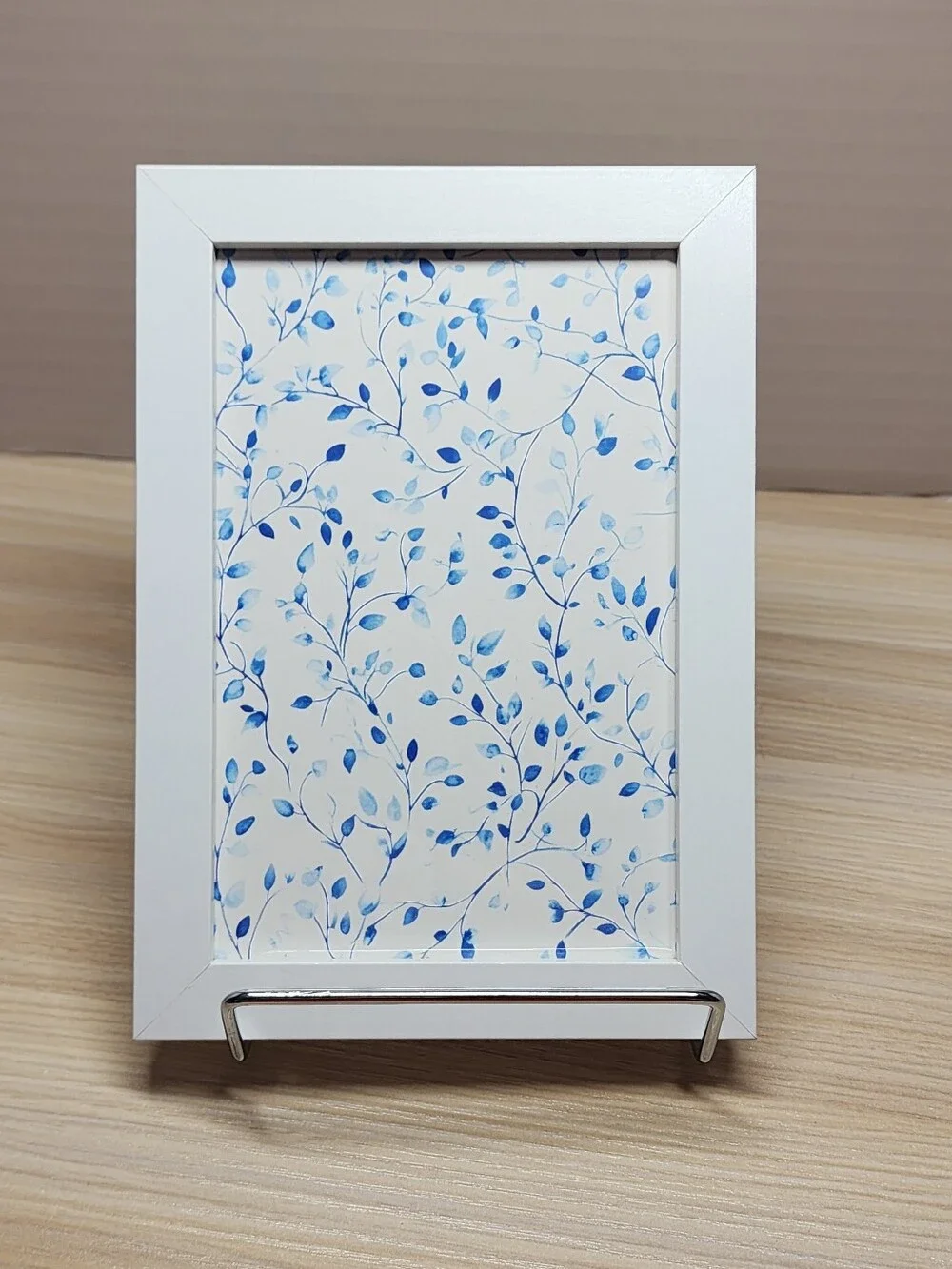 White Frame Wall Art with Blue Leaf Pattern